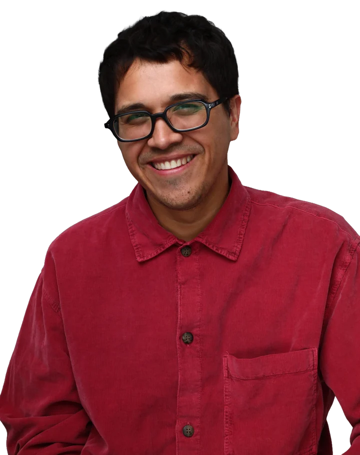 Nick Ciriano smiling in a red corduroy shirt